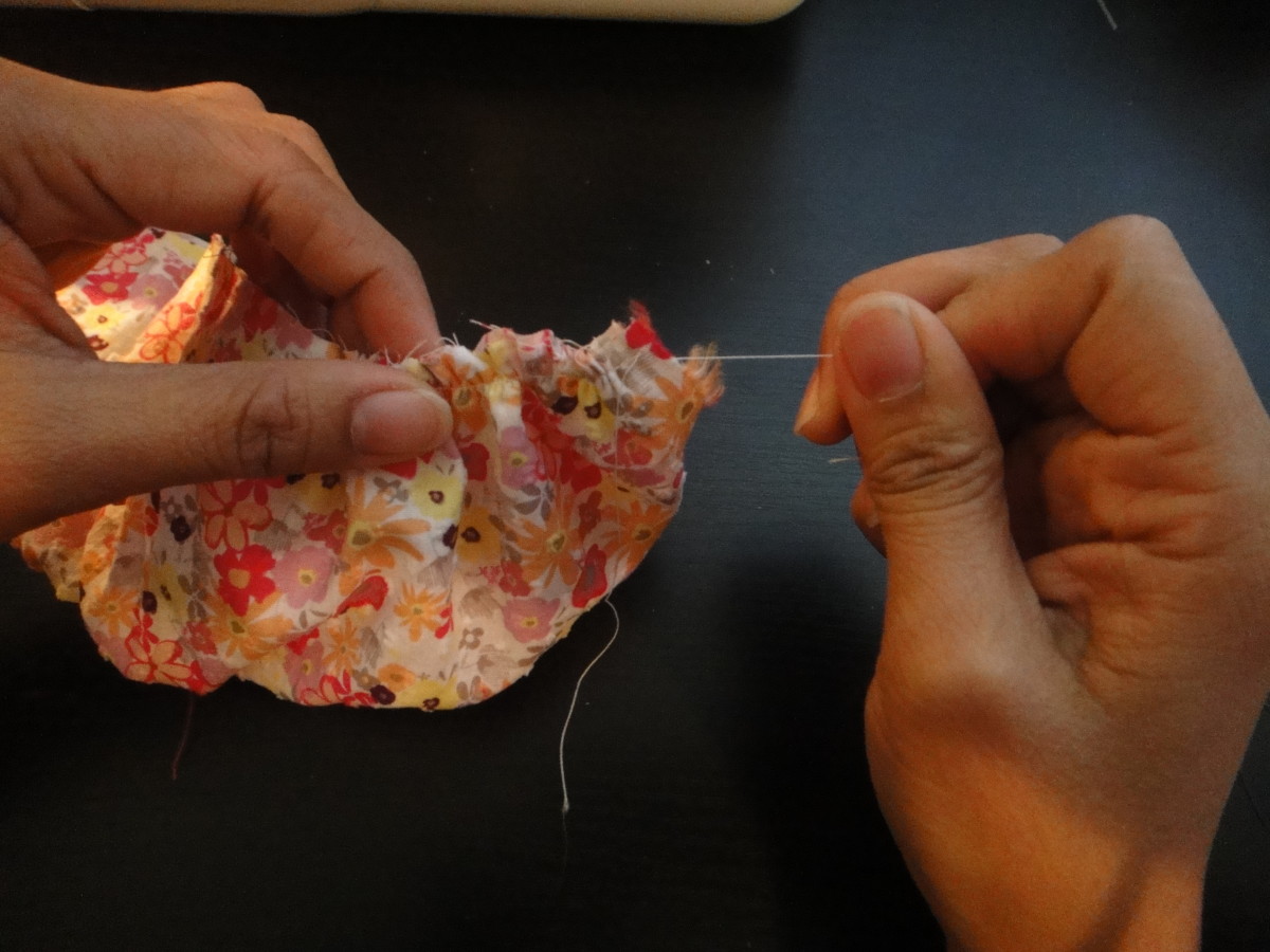 Pull the loose thread to gather the fabric.