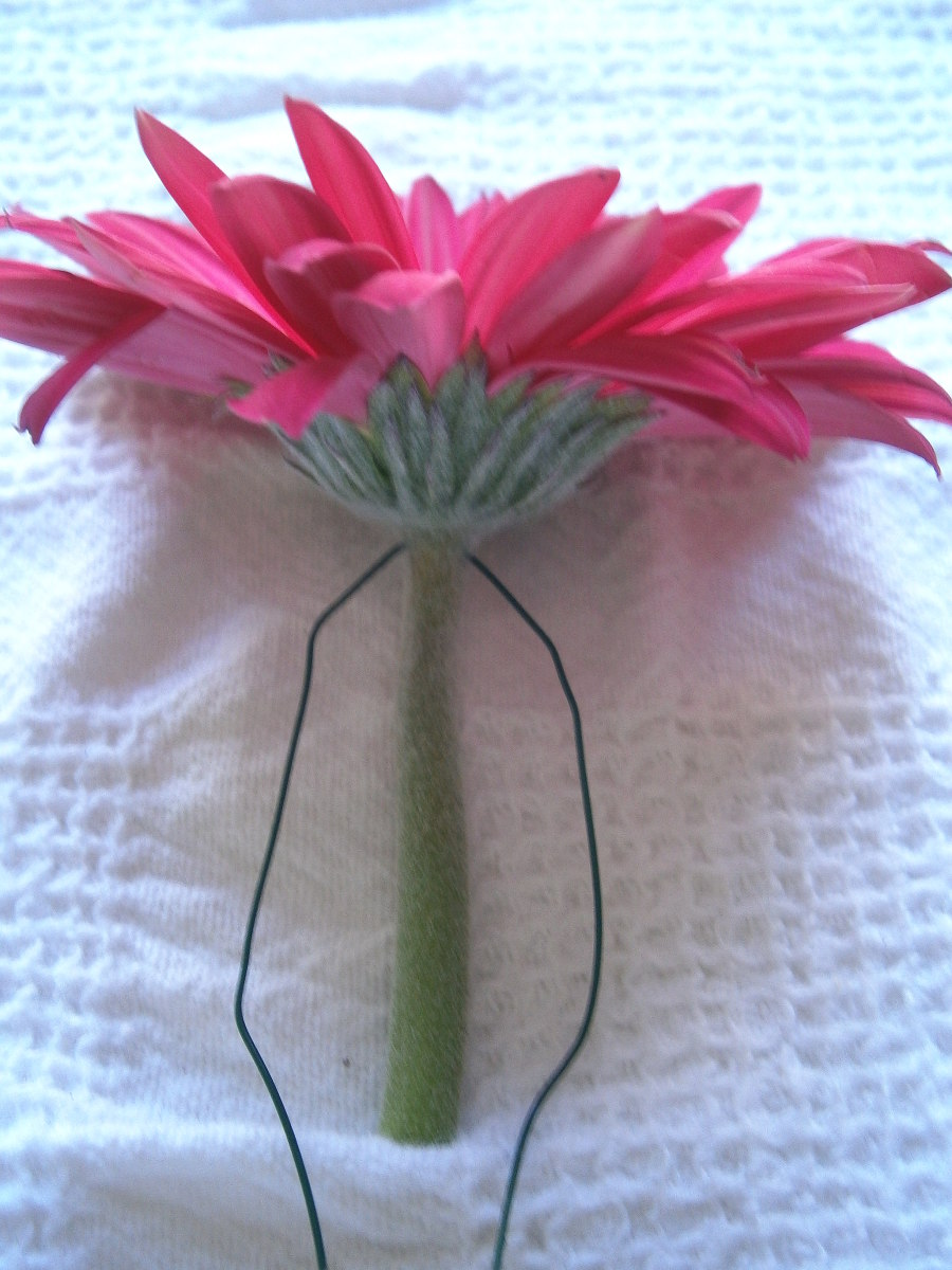 Once the flower is wired, press the wire close to the stem.