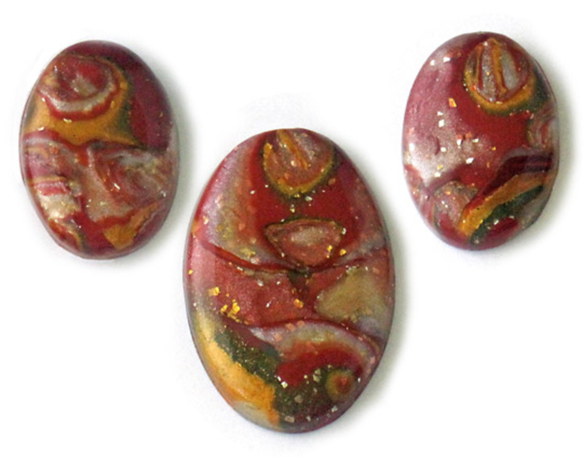 Polymer clay mokume gane cabochons, made with the veneer in the photo in Step 7 that shows how to shave the stack, wet-sanded and glazed