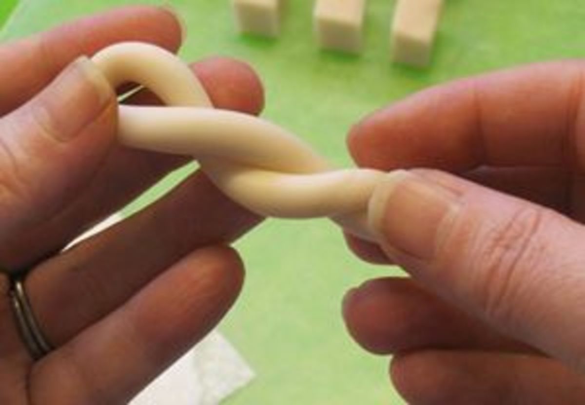 Twisting a folded polymer clay snake as part of the conditioning process