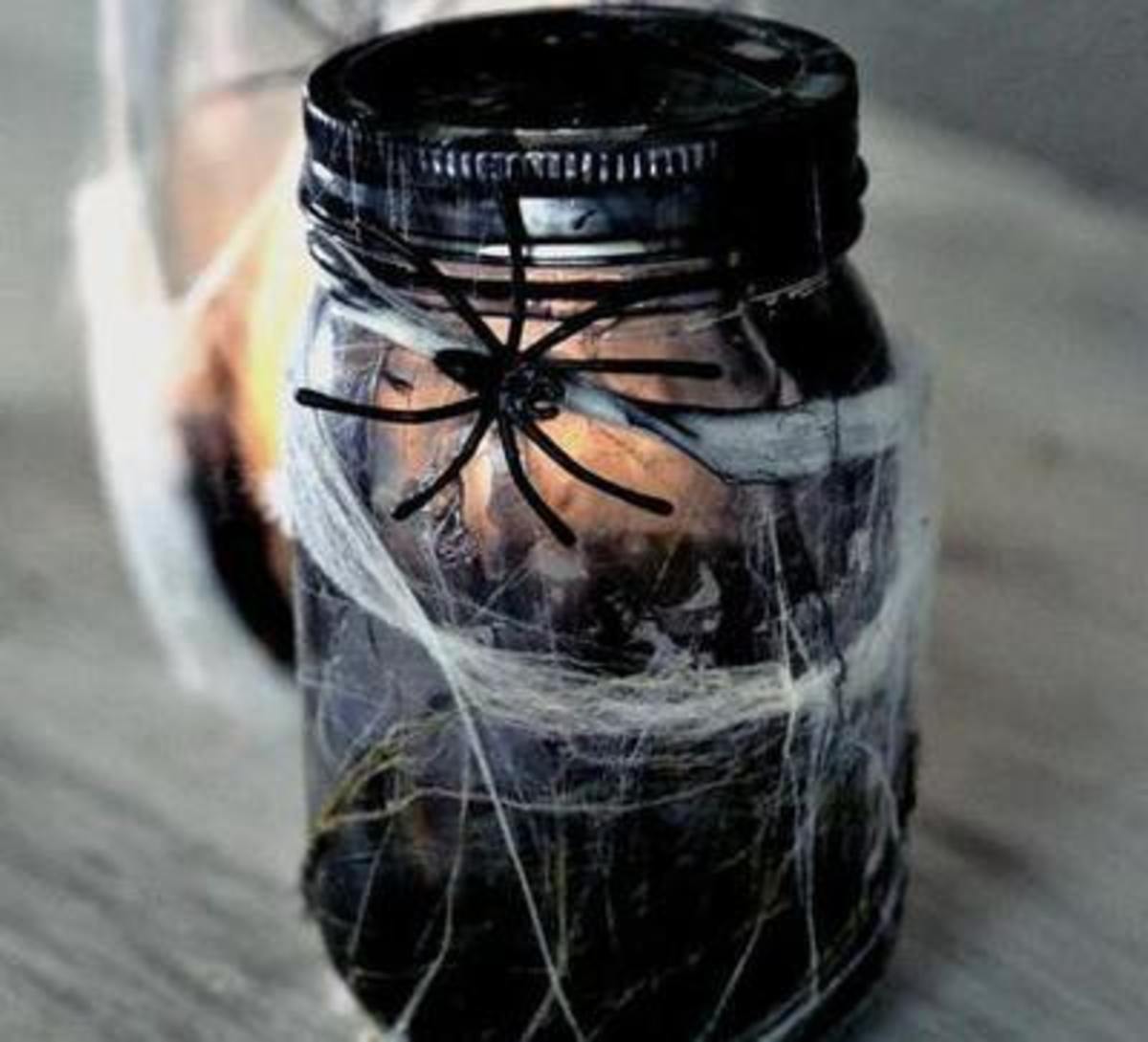 You could make these jars as luminaries or simply scary, spider-covered decorations.