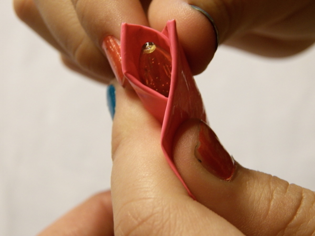  Step 5: Make another petal the same way. Fold a second petal on the other side.  Keep the petal tops level.