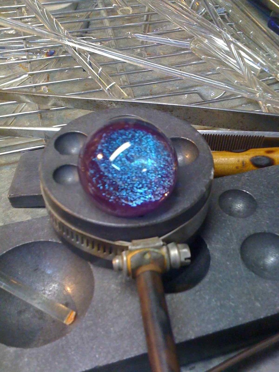 A newly finished glass marble with a dichroic glass center
