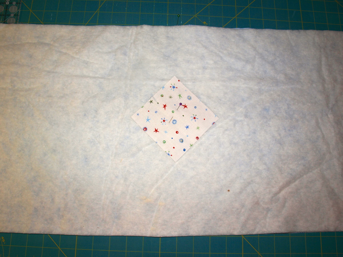Batting placed on top of the backing along with the center square.
