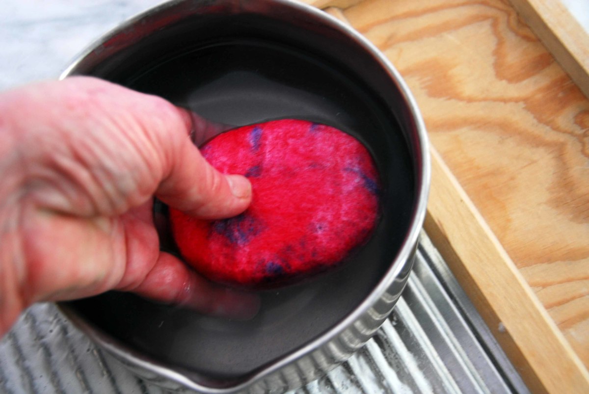 When felted, remove it from the stocking and rinse it in cold water in a bowl or pot.