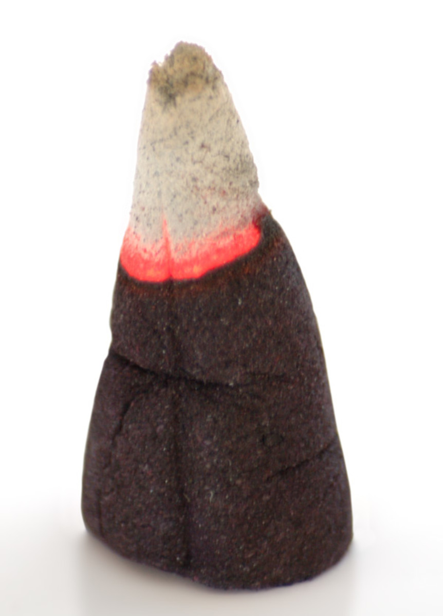 Burning incense pellet in a cone shape. 