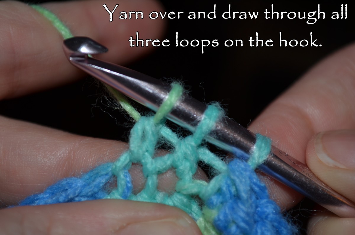 Yarn over and draw through all three loops.