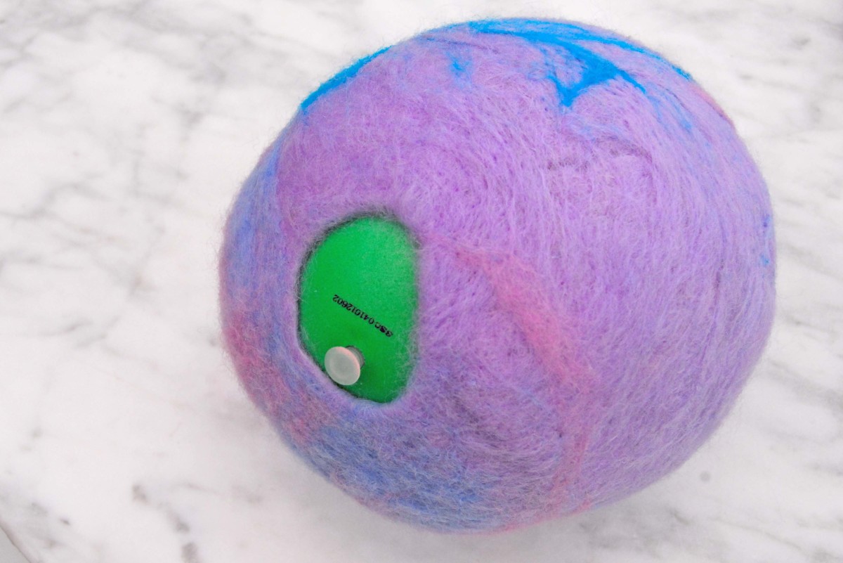 A 'Gertie Ball' was inserted into the bird pod cavity and then blown up.  Wet the Pod with hot soapy water and insert into a tumble drier to complete the felting process.