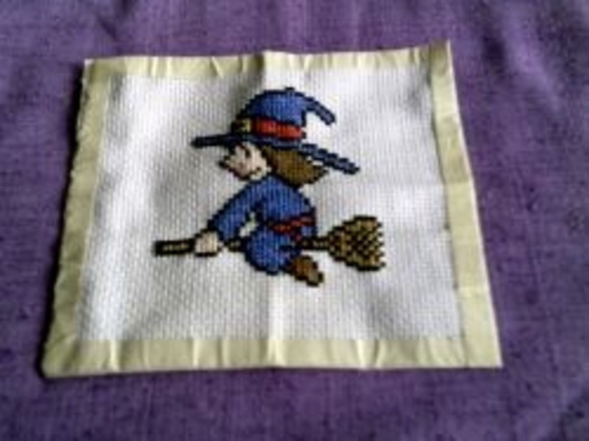 Finished cross-stitched witch.
