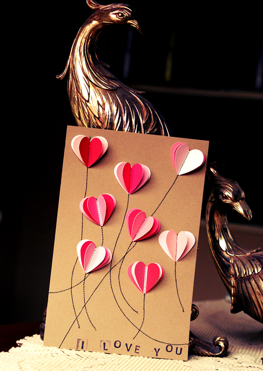 This card idea presents the swatch hearts as three-dimensional balloons being released into the sky. 
