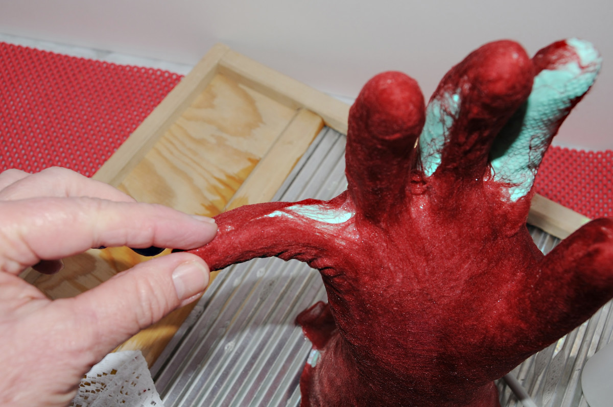 Part the fingers and add the fibers evenly to the whole area.  