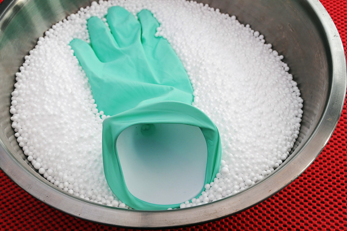 Image shows a Stainless Steel Bowl, Household Glove and  some Polystyrene Balls