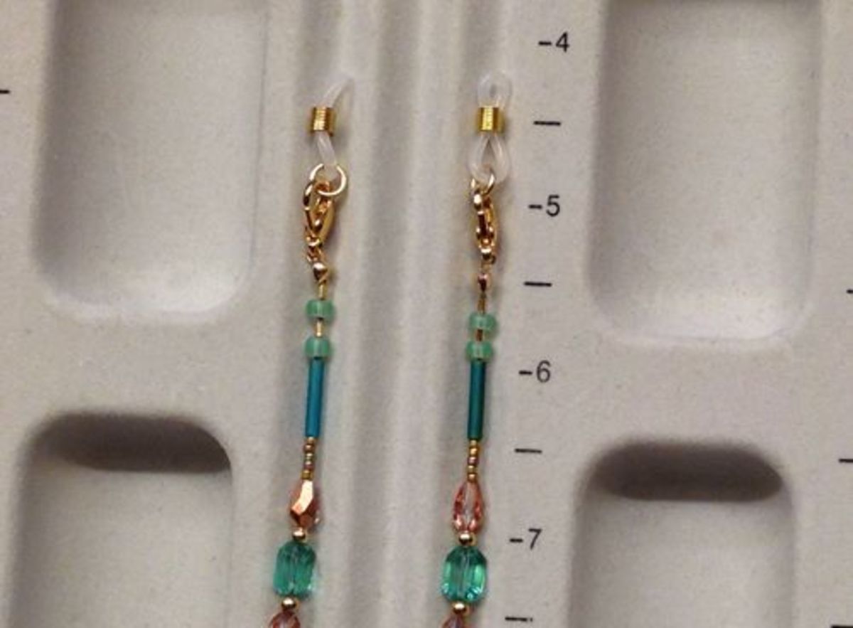 The beaded necklace clasped to the eyeglass holder ends (adapters).