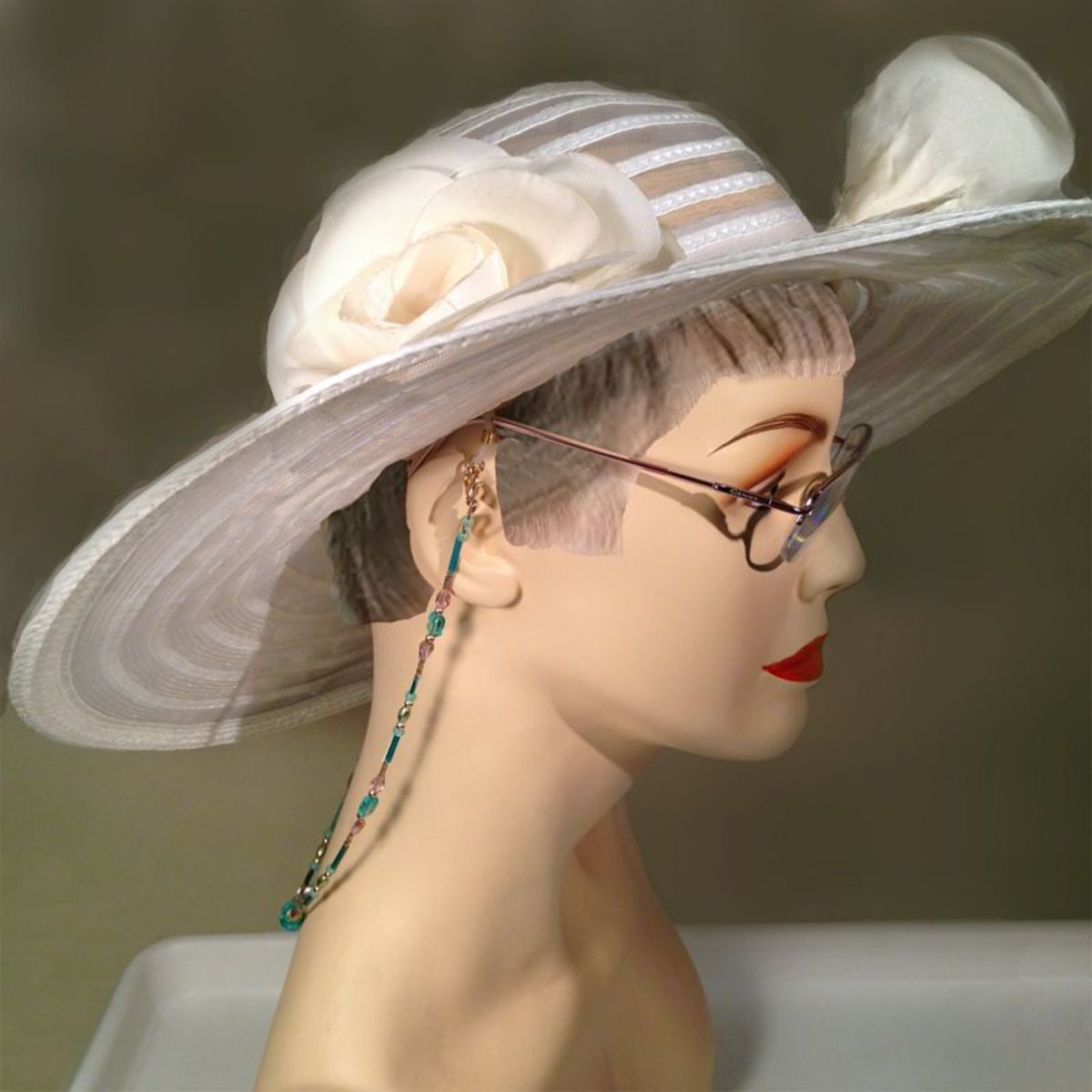 The finished beaded eyeglass chain displayed with glasses on a mannequin