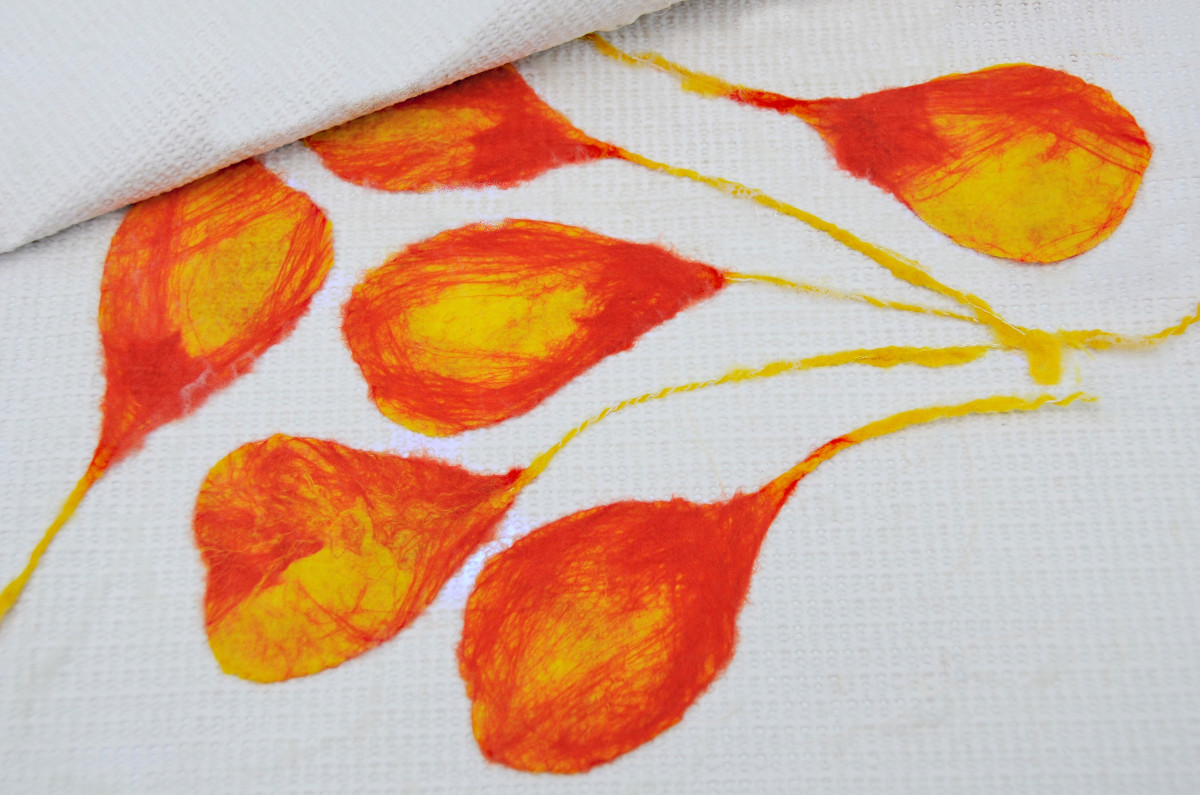 Completed petals arranged between a sheet of thick plastic; in this case, a child's play mat