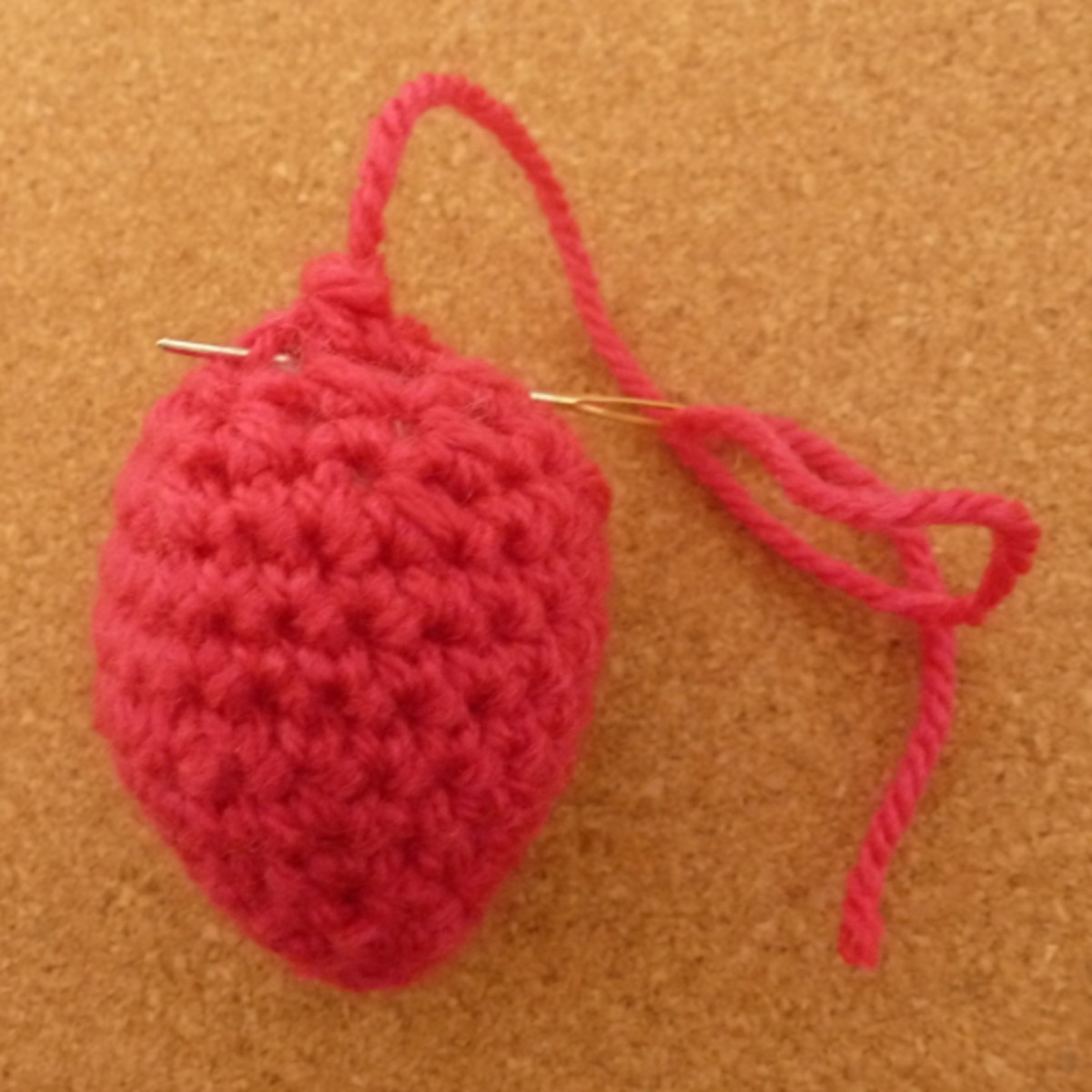 Leave enough thread so that you can sew in the thread to the top of your mini strawberry fruit plush.