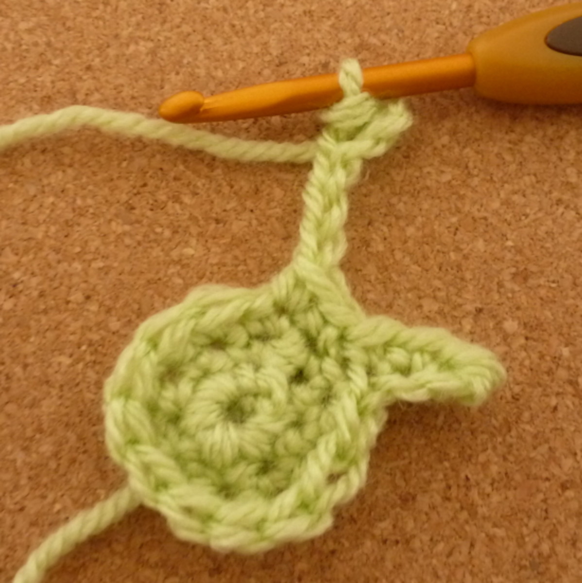 Making the sepals or tiny leaves using chain stitches.