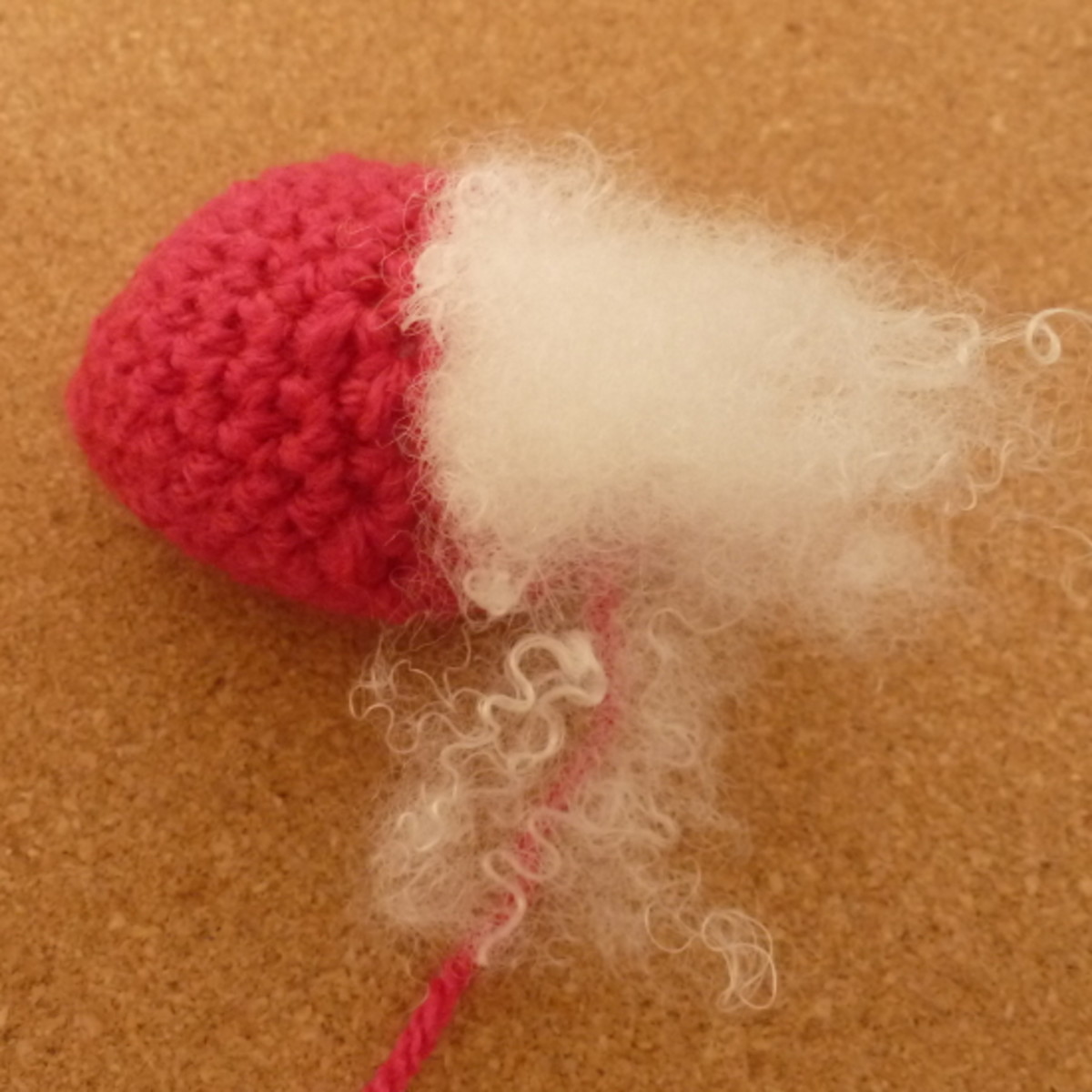 Start to fill your plush crochet strawberry with toy stuffing.