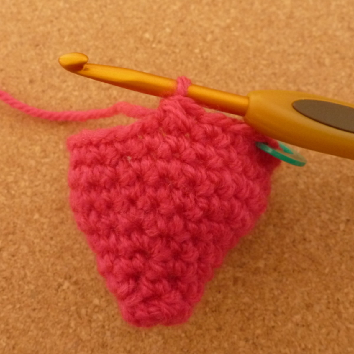 Crocheting round to make a 3D design.
