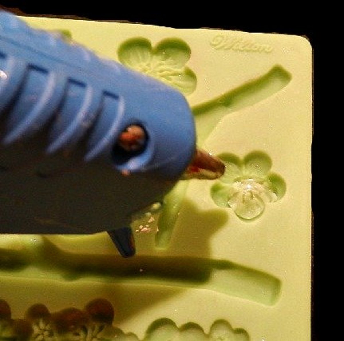 I like to put hot glue in silicone molds to make little 3D embellishments for my scrapbooks. 