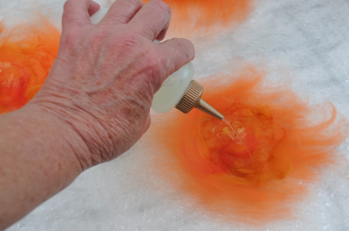 Wetting the wool with hot soapy water