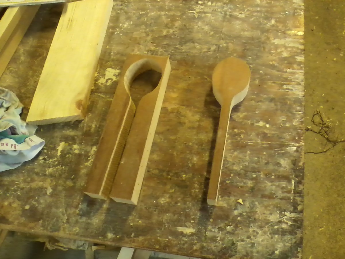 The spoon has been cut out or "relieved" from the board.