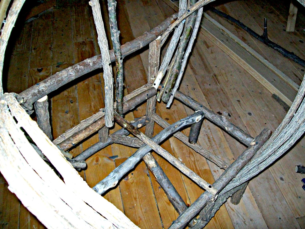 Positioning of Slanted Braces: This is a view of the chair frame showing the position of the slanted braces. You can see the photo was taken after the first seat rail and first two back rails were placed. The seat support can also be seen here.