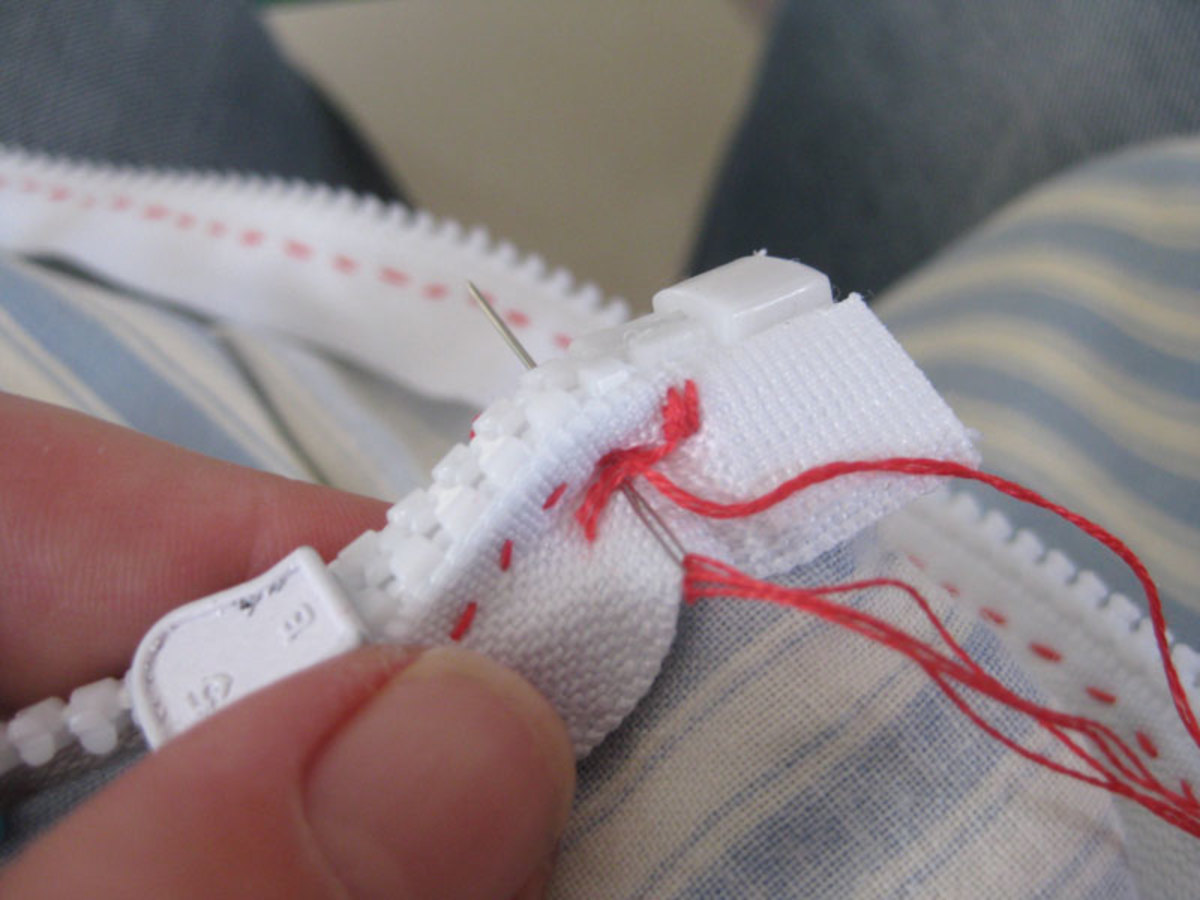 Pinch the zip end together and sew through it a few times.