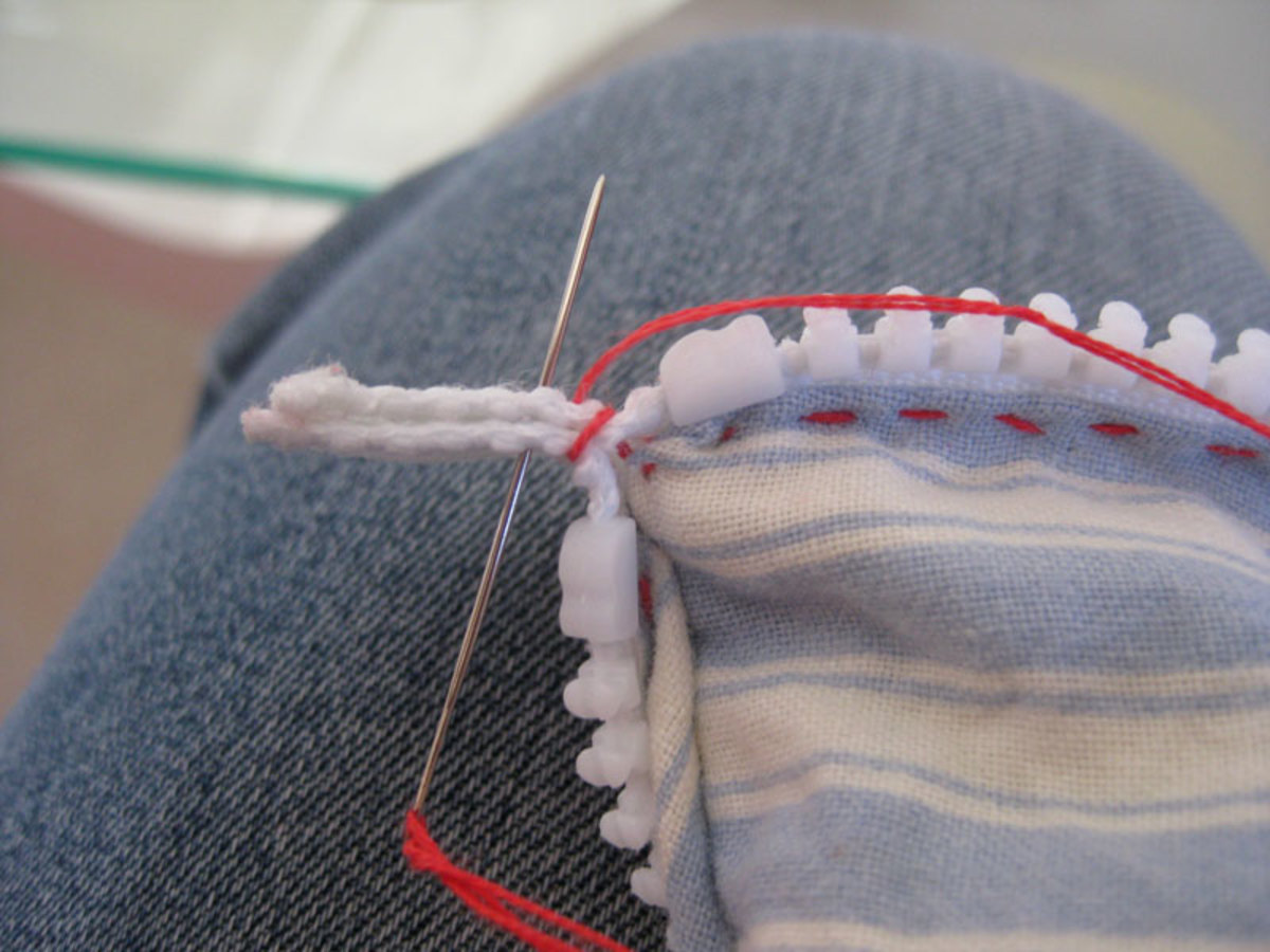 Whip stitch over both of the zip ends.