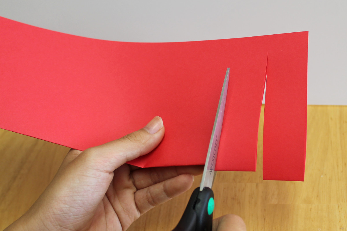 Cut your Chinese lantern from the fold to about one-half inch from the edge of the paper.