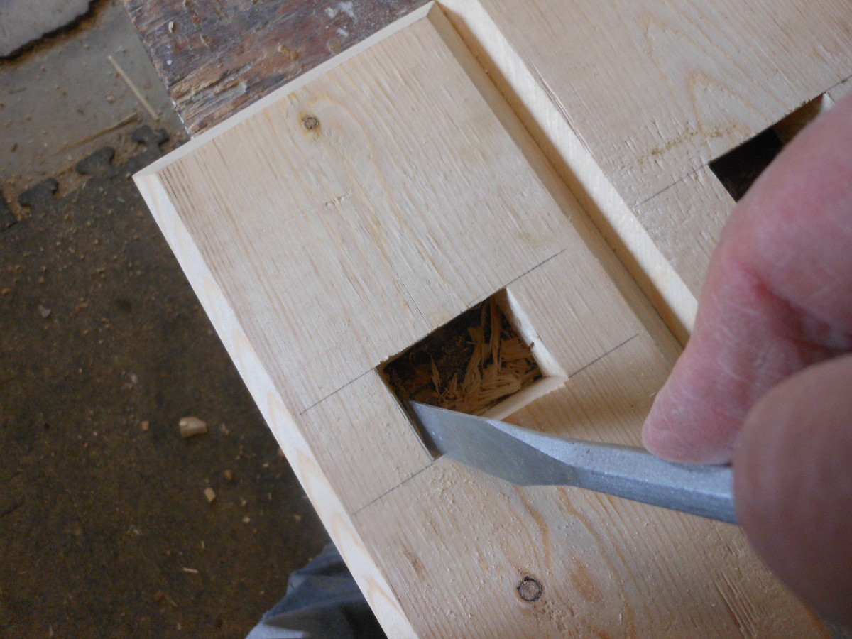Final cleaning of the mortise.  Make sure that the sides are straight so that the tenon can slide through easily.