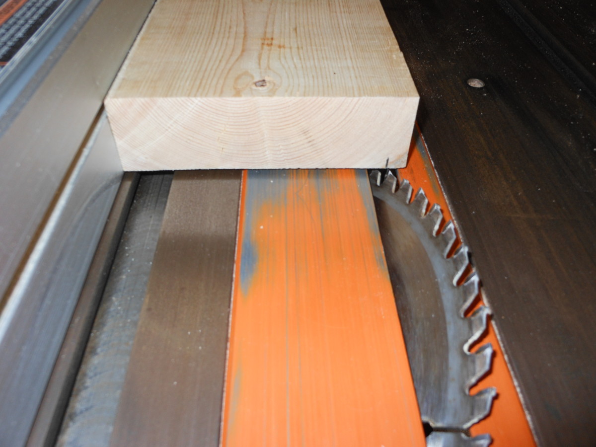 With the table saw blade set at 45 degrees, adjust the rip fence so that only 3/8 of an inch is taken off of the edges.