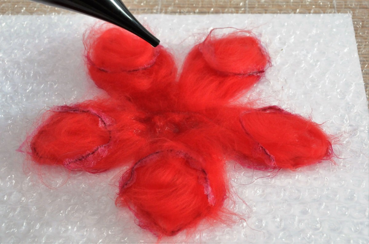 Wet the petals with hot soapy water.