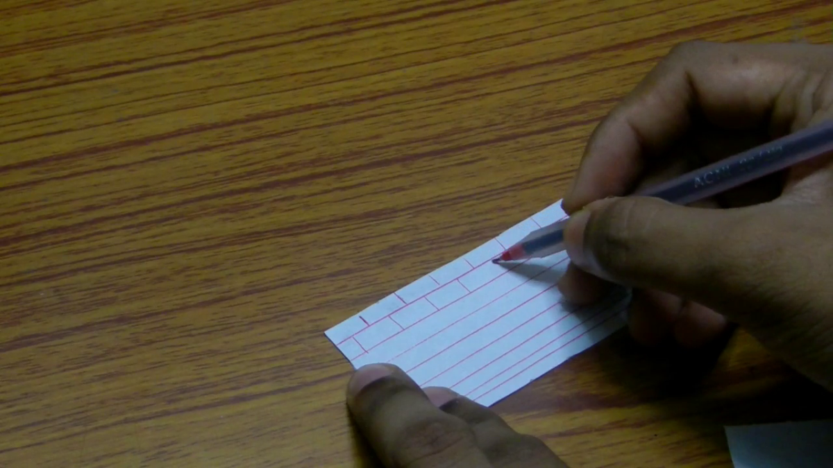 Draw the pattern of the bricks as shown using red pen. Keep in mind that each brick has a same length. So draw the bricks maintaining the same length.