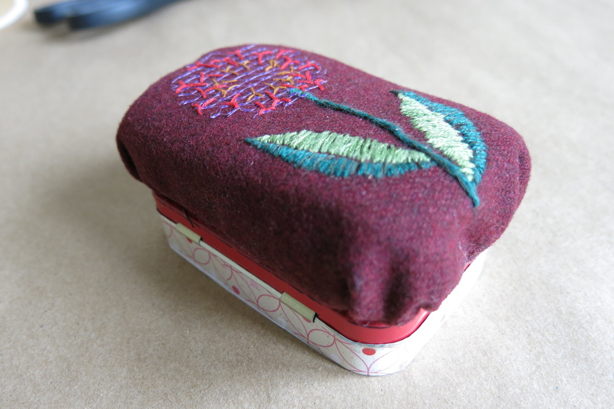 Gluing the pincushion to the top of the tin