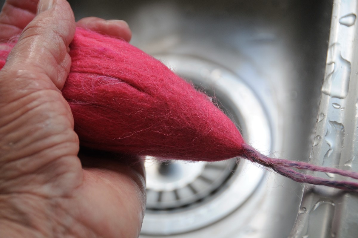 Add a little soap to the exposed end of the flower and rub well until the fibres felt together.