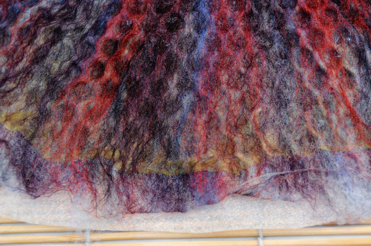 Remove the Bubblewrap From One Side of the Project: The silk layer can just be seen through the fine layer of wool roving