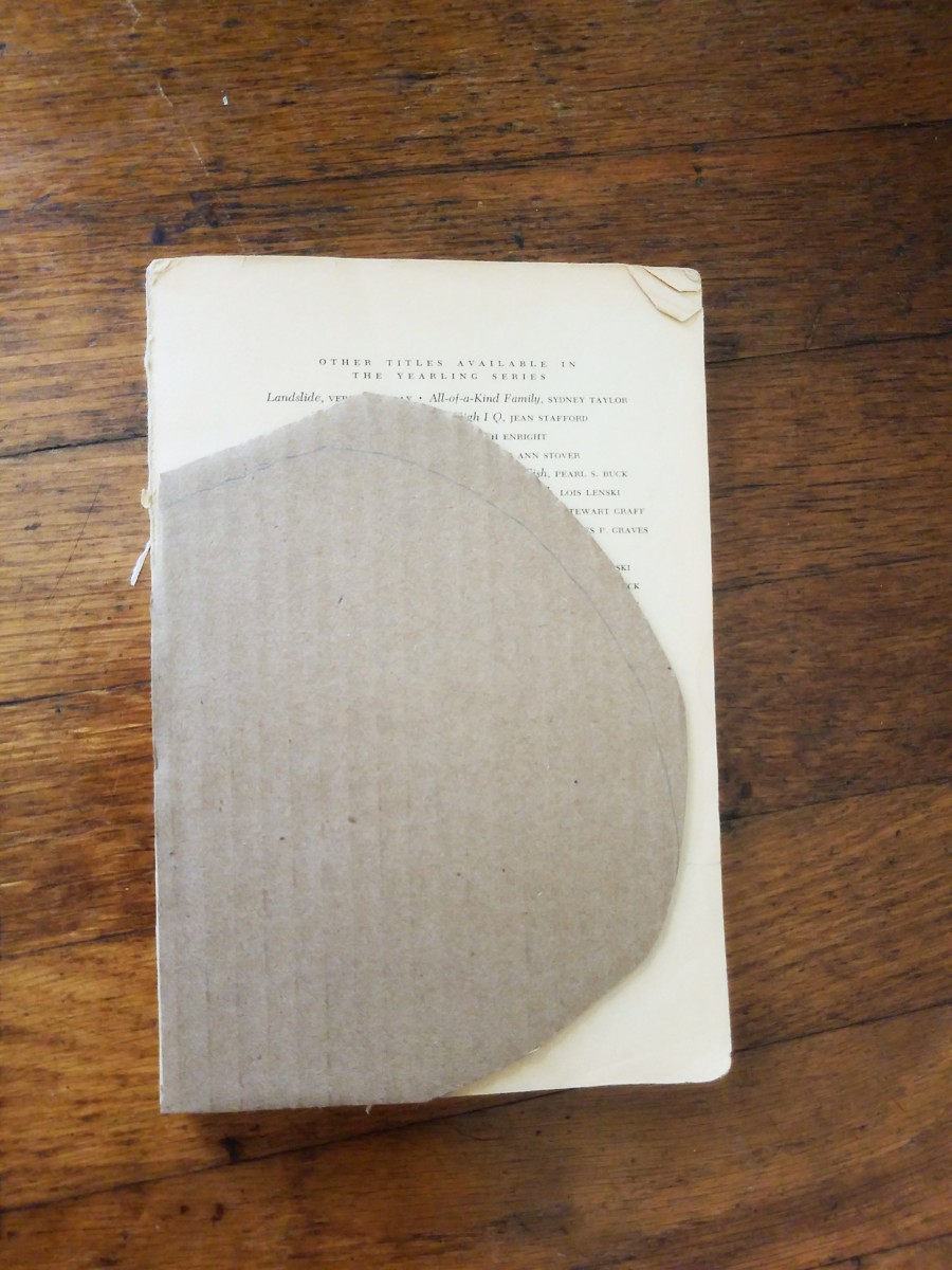Use your cardboard as a guide to cut your book pages.