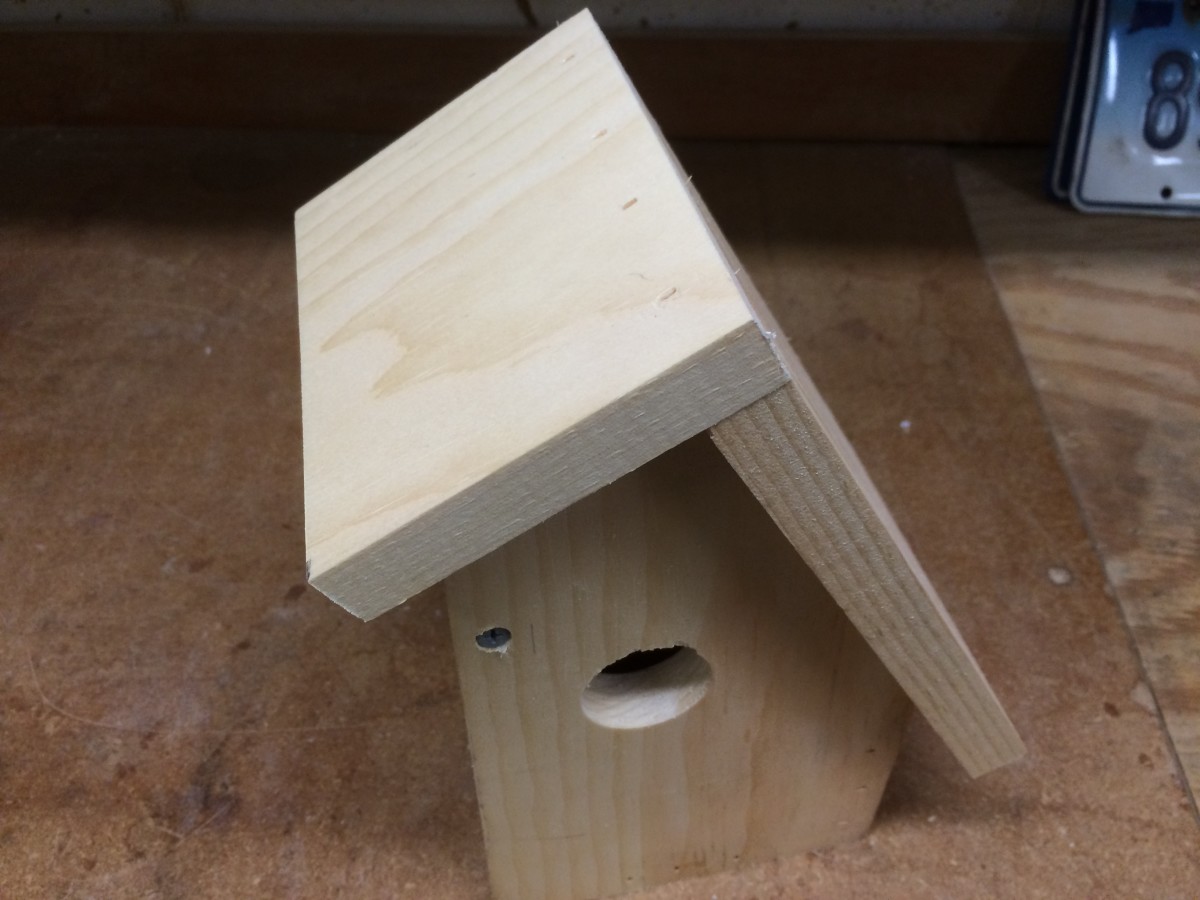 Attaching the roof to the birdhouse.