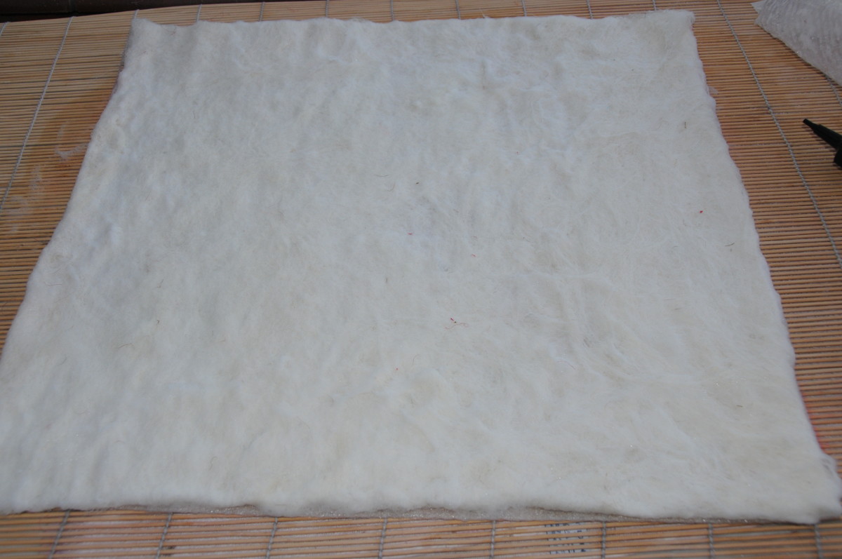 Cover the rectangular template with the white wool.