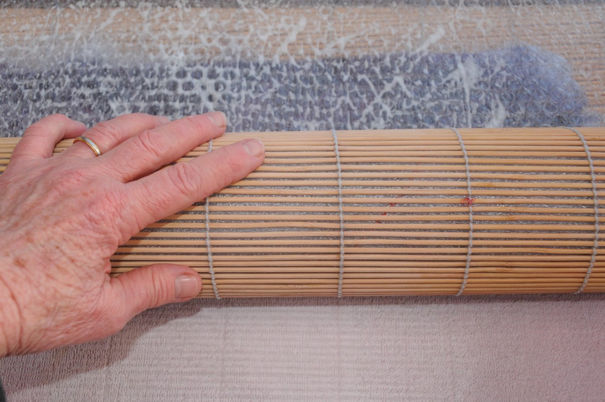 Gently roll up the project inside the bamboo blind.