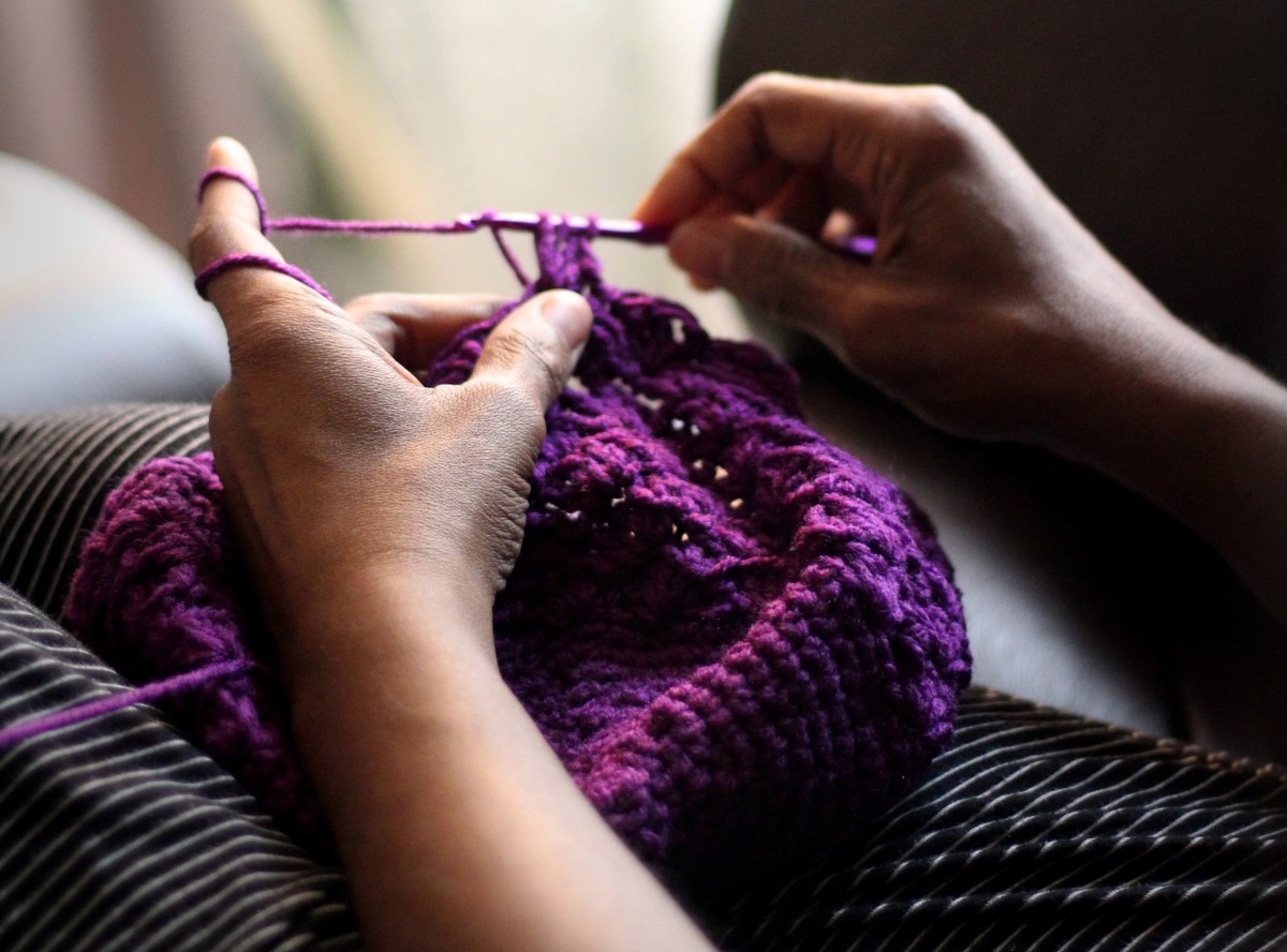 Crocheting with crochet hook. 
