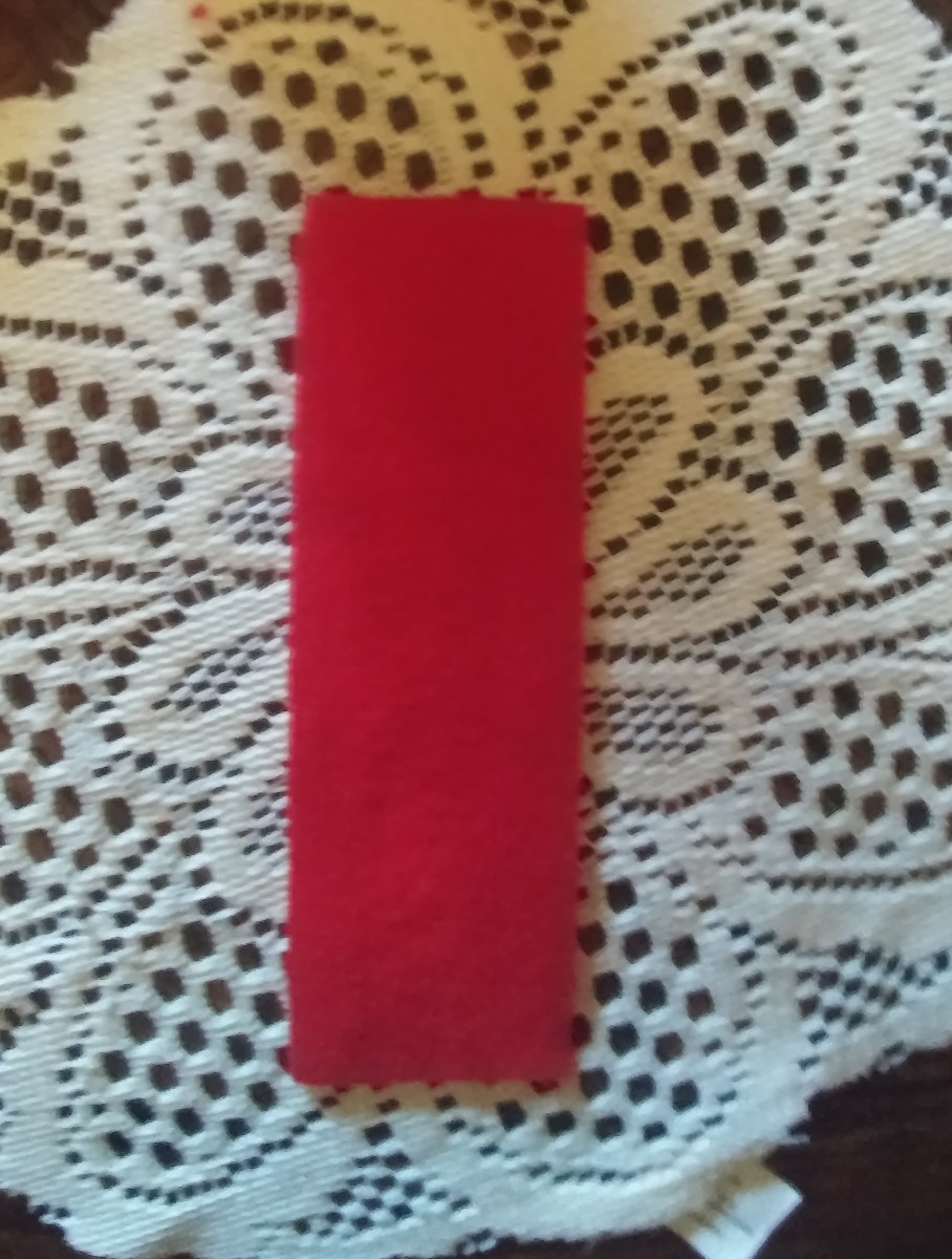 Cut felt into the shape of bookmark. This one measures 7 by 2 and a quarter inches.