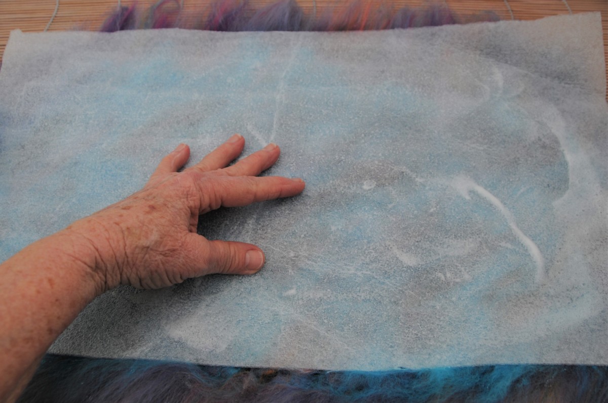 Rubbing and smoothing down the wet fibers