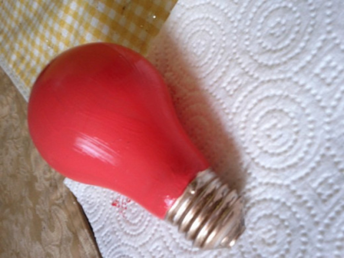 Place a paper towel beneath the bulb to protect the surface from paint splatter. 