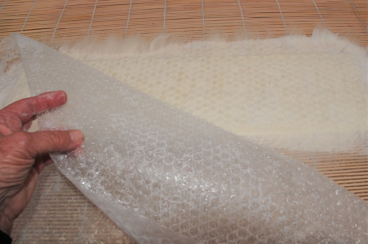 Gently remove the bubblewrap from the flattened wet fibers.