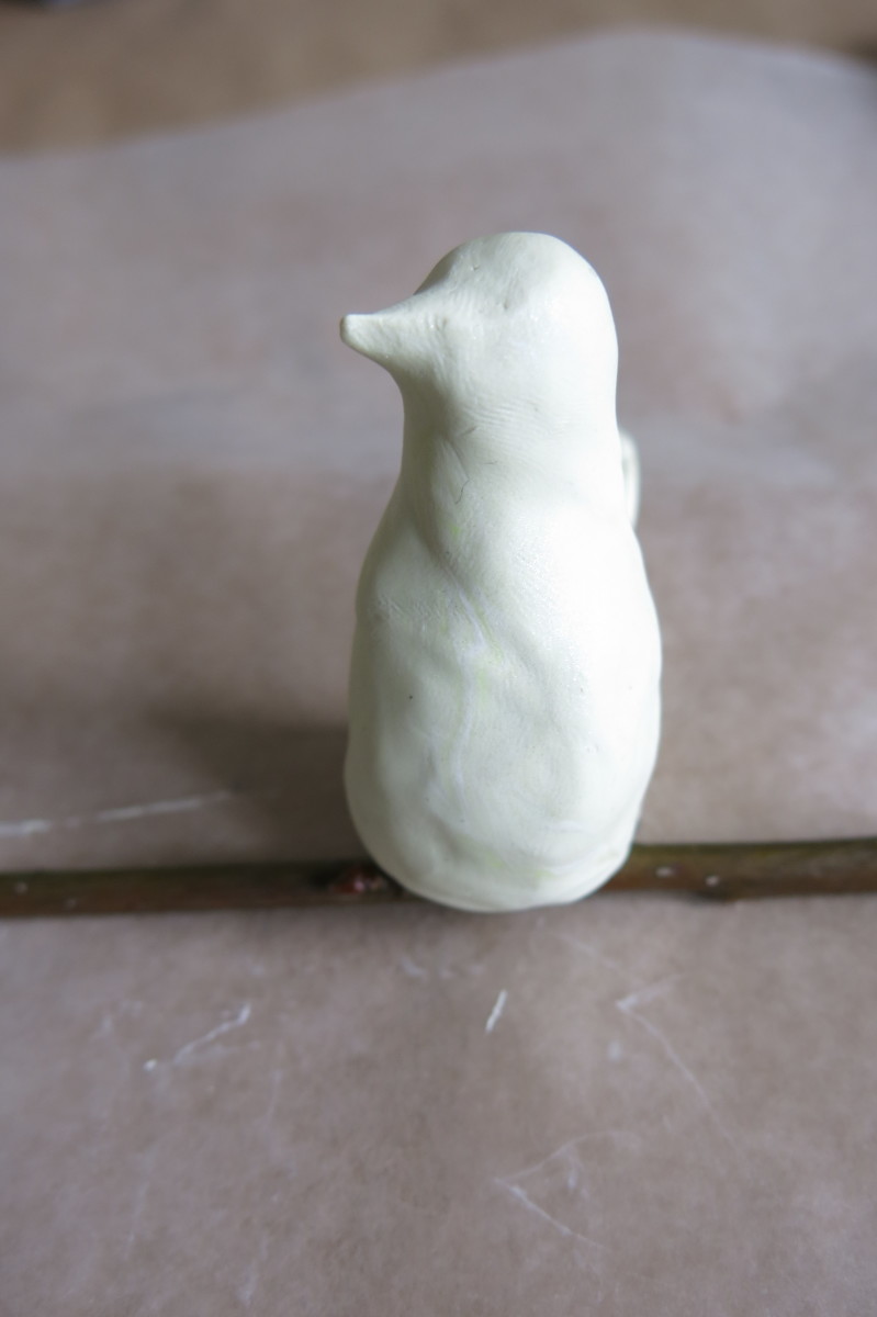Putting the finishing touches on your decorative clay bird.