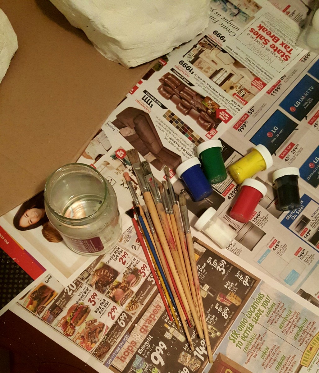 Gather painting materials. Brushes, paint, and water.