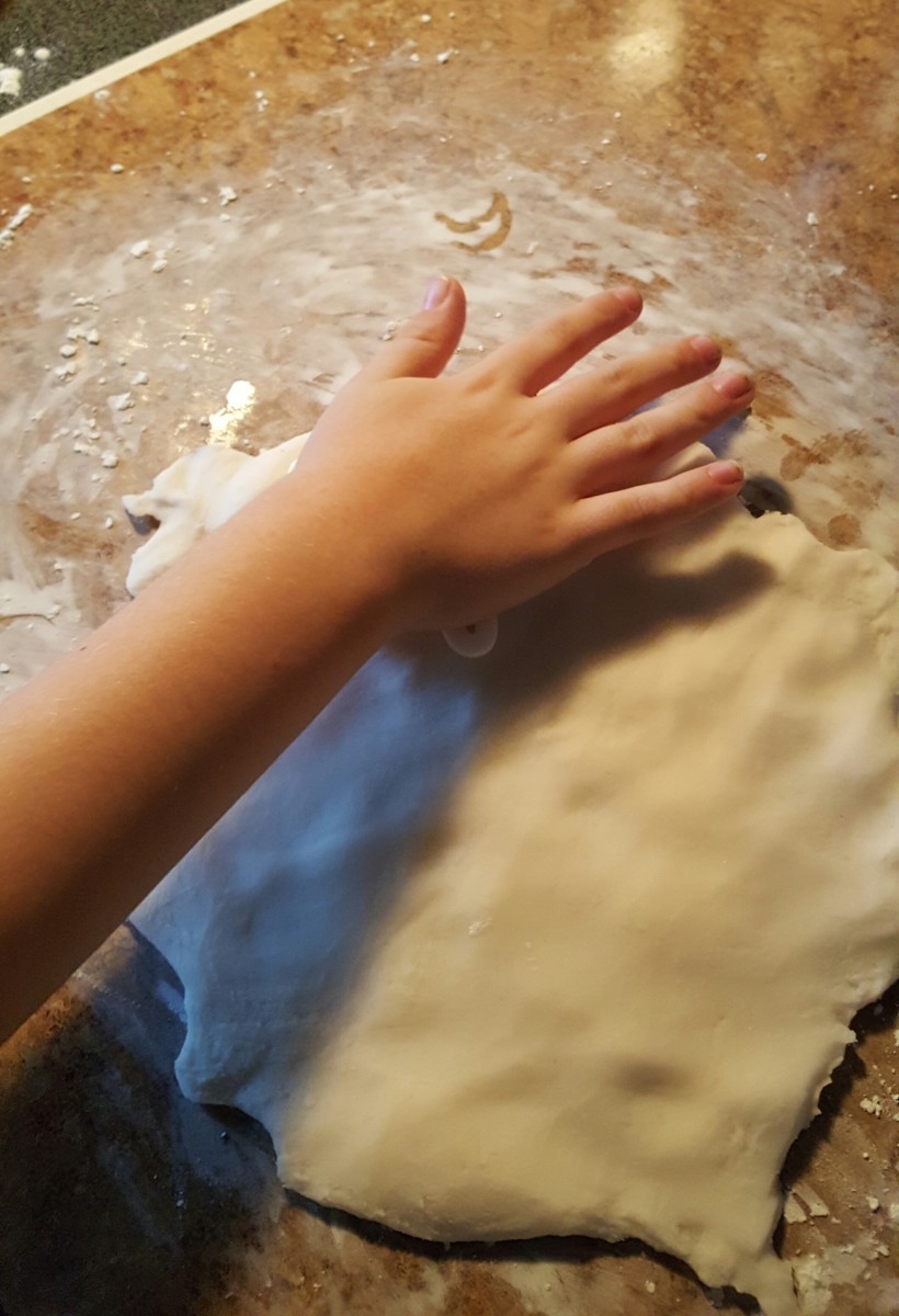 Knead the dough and flatten it out. Use your cookie cutter to make the snowflake shapes.