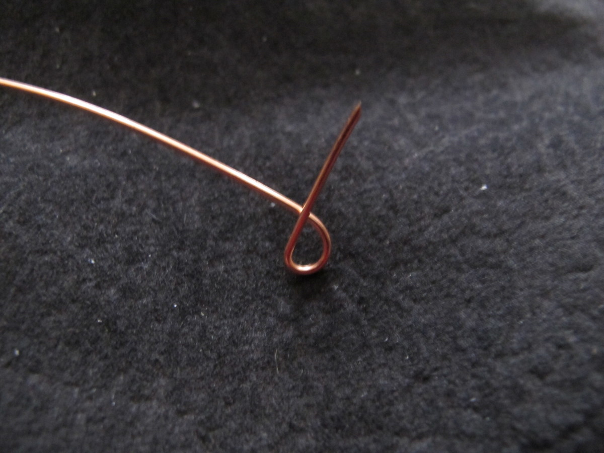Create a loop toward one end of the wire, leaving a half inch "tail."